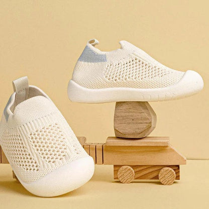White slip-on shoes with blue accents
